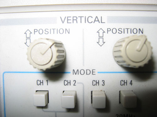 Vertical alignment knobs of an oscilloscope's interface.
