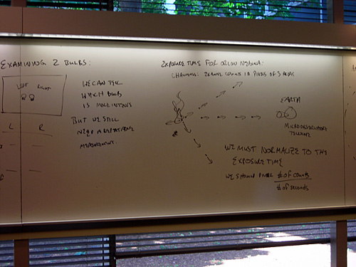 Notes on a whiteboard about flux exposure time.