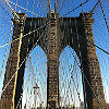 Image of the Brooklyn Bridge taken from on the bridge, looking up.