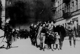 A photograph of jewish civilians during the destruction of the Warsaw Ghetto, 1943.