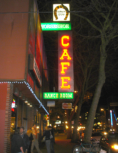 Bright neon lights advertise a restaurant.