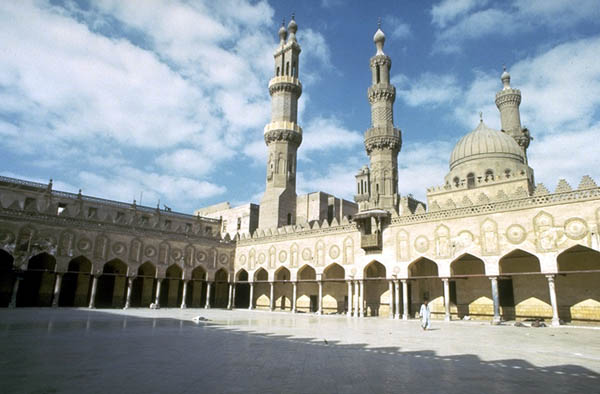 View of the Northwest portico of the mosque with the three minarets in the background.
