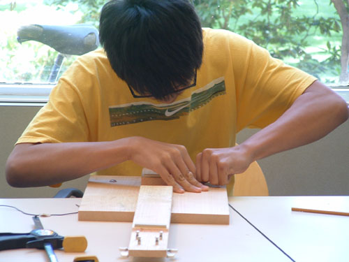 Student working on his guitar.