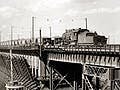 Black and white photo of a ship at an iron ore docks.