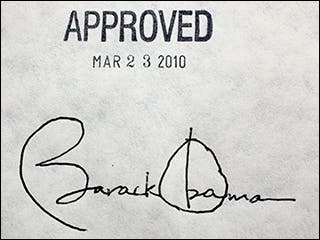 A photograph of a piece of paper, with President Barack Obama's signature at the bottom and a stamp above it that reads "APPROVED MAR 23 2010."