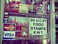 A deli window in Brooklyn with a sign that reads "We accept food stamps and EBT".