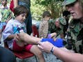 A little girl gets new shoes and socks.
