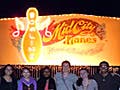 Eight students pose in front of a bowling alley.