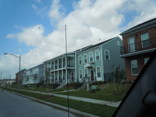Newly built homes stand in a row along a street.