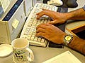 Hands typing on a keyboard.