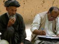 Photograph of men answering survey questions.