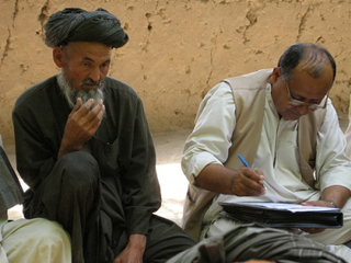 Photograph of men answering survey questions.