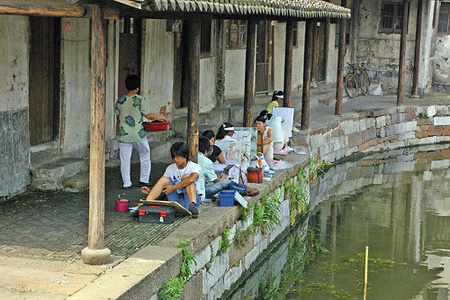 Artists painting along the canal.