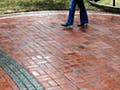 Photo of feet along a brick-paved path.