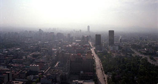An aerial photo of Mexico City, partially obscured by smog.