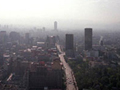 An aerial photo of Mexico City, partially obscured by smog.