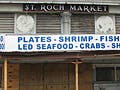 A photograph of a dilapidated abandoned market that used to sell produce and seafood.