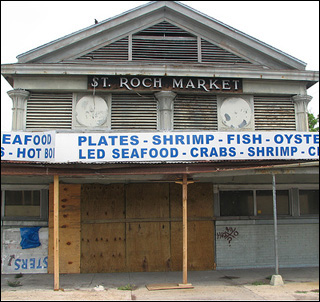 A photograph of a dilapidated abandoned market that used to sell produce and seafood.