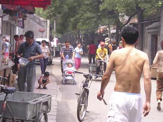 A photo of a small busy street in China.