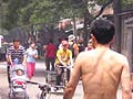 A photo of a small busy street in China.