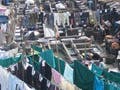 Photo showing a crowded area with laundry hanging throughout.