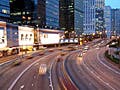 Photograph of a city and highway at night.
