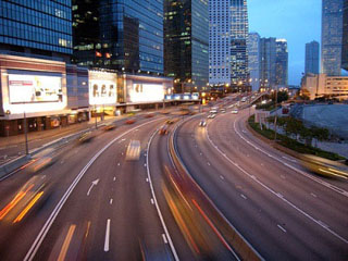 Photograph of a city and highway at night.