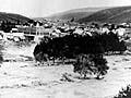 A photogrpah of a flash flood ravaging a town.