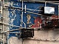 A network of pipes crisscross the outside of a building.