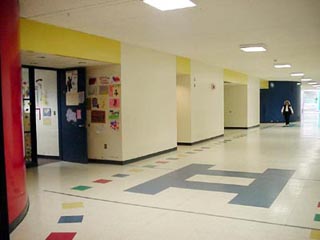 A photo of a wide school hallway.