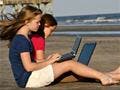 Two girls working on the beach.