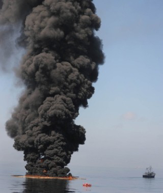 Photograph of large plume of smoke from a controlled burn of an oil spill.