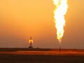 Oil rig and flare at sunset.