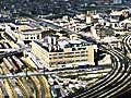 Two aerial photos, one of undeveloped land in Mexico, the other an industrial city.