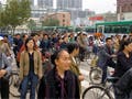 Pedestrians, bicyclists, and buses during rush hour traffic.
