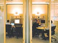Employees working and holding meetings in modern office building.