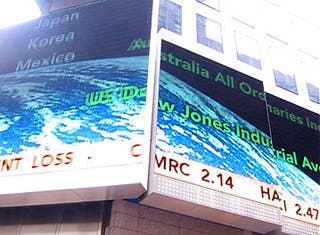 Phot of a billboard displaying a stock ticker.