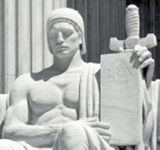 A statue of a man holding a law tablet.