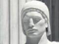 A statue of a man holding a law tablet.