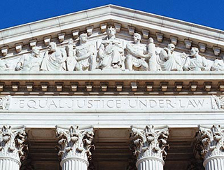 A photo of the top of the U.S. Supreme Court building.