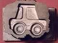 A mold of a toy car and a casting of the car.