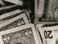Image of scattered US currency.