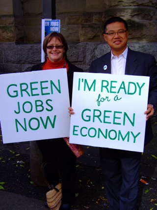 People with signs supporting a green economy.