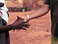 A volunteer and a local shake hands.