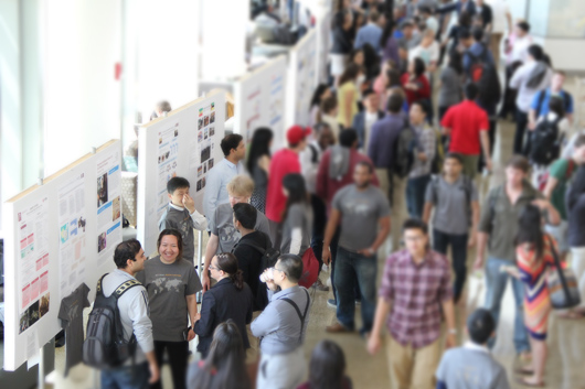 People speaking in front of a poster.