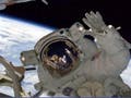 Photo of an astronaut in space with the Earth behind.