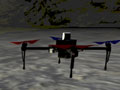 A drone flying over a terrain and a few other vehicles on that terrain as well