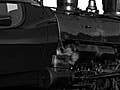 Image of a vehicle depicting the transition from coal-powered transportation to transportation via modern technologies.