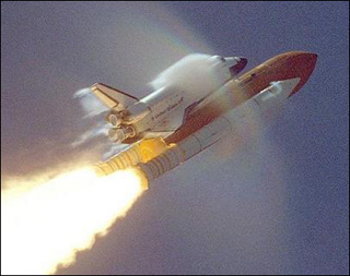 The shuttle passes Mach 1, producing shockwaves.