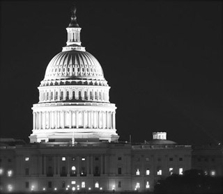 Black and white photo of U.S. Capitol at night.